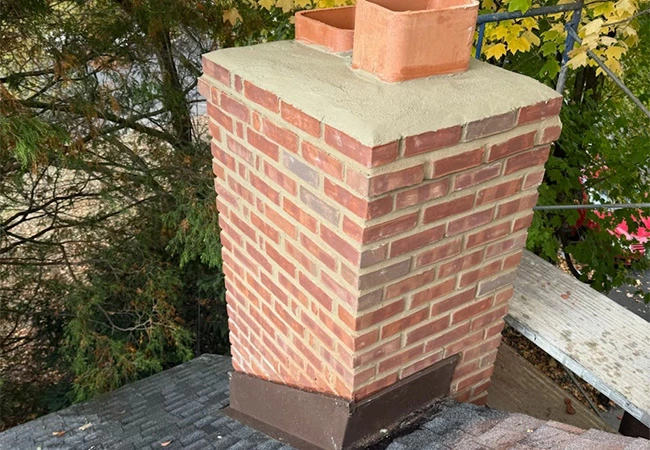 Chimney flashing and masonry repair on a residential roof in Bergen County